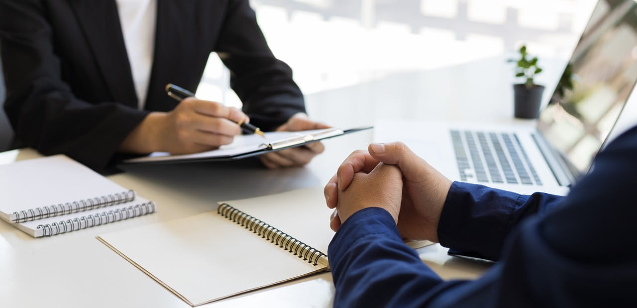 Business owner conducting an exit interview with an employee.